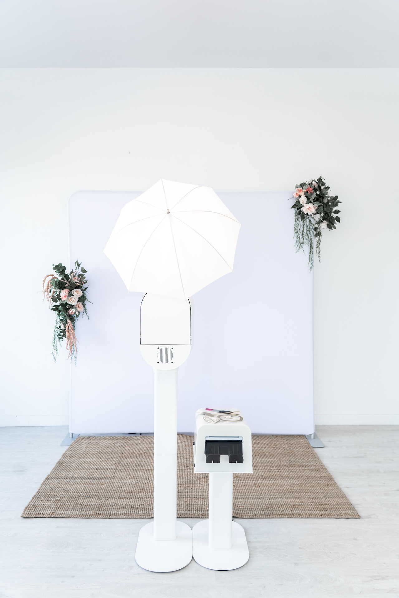 Shutterhead Studios photo booth with printer and white backdrop with flowers